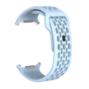 Close-up detail of the light blue perforated silicone watch band connector and breathable holes.