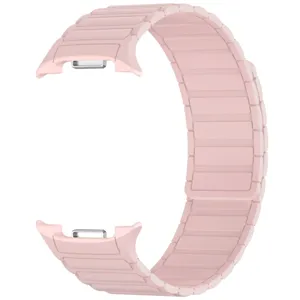 Close-up detail of the pink magnetic silicone watch strap featuring segmented design and connectors.
