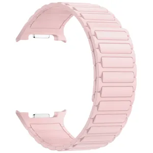 Close-up of pink silicone magnetic watch strap, featuring flexible segmented link design.