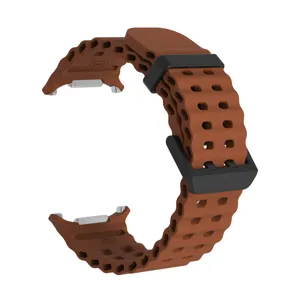 Brown silicone watch band with breathable holes, black buckle and silver connectors detail.