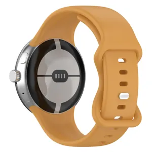 Silicone replacement watch strap detail showing the orange color, texture, and metal buckle.