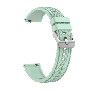 Close-up detail of the light green silicone watch strap showing quick release pin and metal buckle.