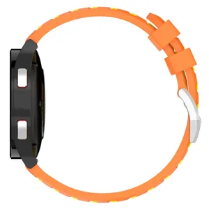 Silicone watch strap side detail showing textured orange tire pattern and metal buckle.