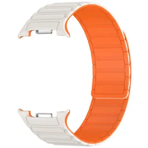 Detailed close-up view of the white exterior and orange interior magnetic silicone watch strap.