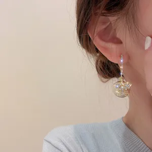 Closeup detail of Korean style bow pearl earrings featuring rhinestone hoop and S925 silver needle.