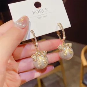 Exquisite S925 silver needle pearl bow earrings detail, stylish rhinestone hoop design.
