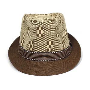 Detail view of men's woven straw fedora hat, featuring beige geometric crown and brown brim.