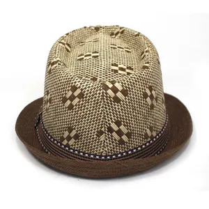 Close-up view of woven straw fedora hat texture, brown brim and geometric pattern detail.
