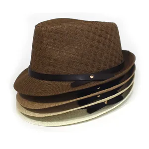 Detailed view of stacked woven paper straw fedora hats featuring stylish leather bands.