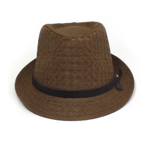 Close-up detail of the brown woven straw fedora hat with dark leather band and metallic rivet.