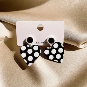 Black and white polka dot heart earrings with display card, stylish geometric chic jewelry.