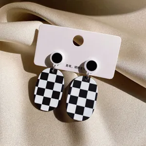 Black white checkerboard oval earrings geometric retro dangle earrings detail view.