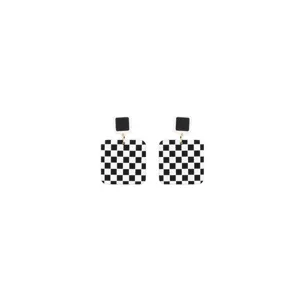 Detailed close-up of black and white checkerboard geometric earrings with silver needles.