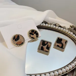 Retro leopard print earrings with gold twist border, chic geometric design for women autumn.