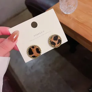 Leopard print round earring detail, gold twisted metal border, chic fashion accessory.