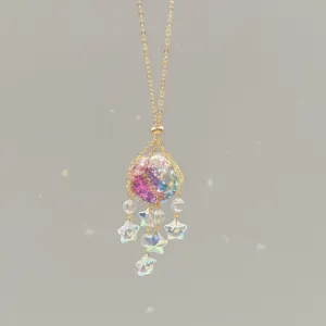 Crystal suncatcher detail showing multi-color glass ball and shining star charms hanging.