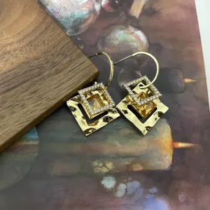 Gold geometric square earrings with sparkling rhinestones and yellow crystal stones, elegant fashion.