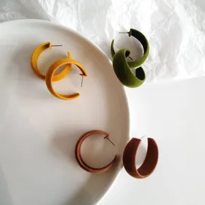 Close-up detail of vintage velvet hoop earrings showcasing soft flocking texture and vibrant colors.