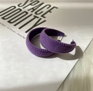 Detailed close-up of retro purple flocked hoop earrings, showcasing unique vintage texture.