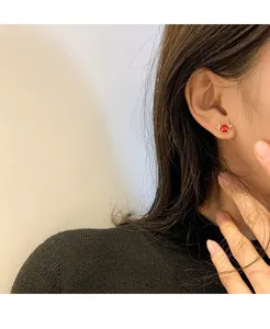 Red ox ear stud detail view, delicate jewelry close up for daily wear and gifting.
