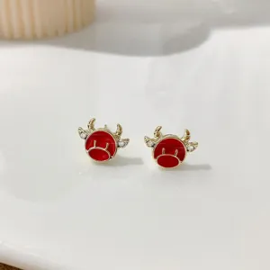 Red enamel bull stud earrings with 925 silver needle, cute animal design close up view.