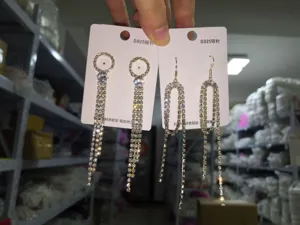 Detailed view of S925 silver needle rhinestone geometric tassel earrings hanging on display cards.