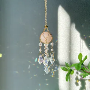 Crystal suncatcher detail shot showing sparkling multi-faceted glass prisms and pink crystal ball.