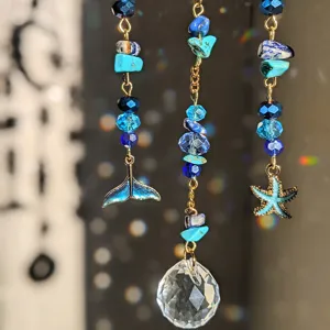 Blue crystal suncatcher hanging pendant with ocean charms and rainbow light effect.