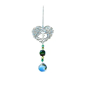 Crystal suncatcher detail showing the tree of life heart pendant and blue crystal ball.