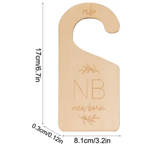 Wooden baby clothes size divider detail showing dimensions and engraved newborn text clearly.