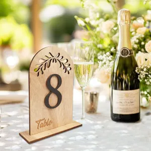 Rustic wooden wedding table number detail, arch design with leaf cutout and number eight.