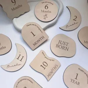 Wooden baby milestone cards detail view, laser engraved wooden discs for newborn photography.