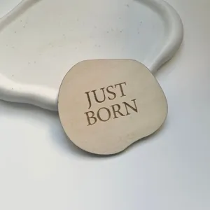 Wood baby birth announcement sign detail, newborn milestone disc, laser engraved photography prop.
