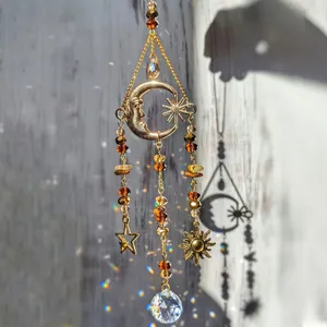 Detailed close-up of a crystal suncatcher featuring golden moon, sun, and amber beads.