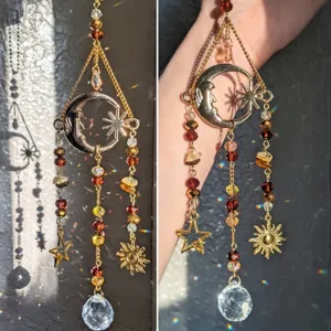 Crystal suncatcher hanging ornament detail showing sparkling moon star sun charms and light reflection.