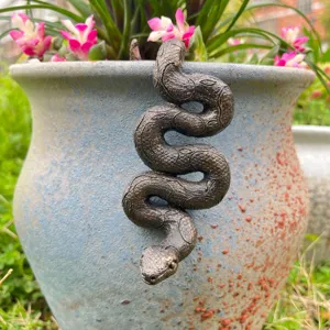 Bronze snake flower pot companion detail showing texture and hanging design for garden decor.