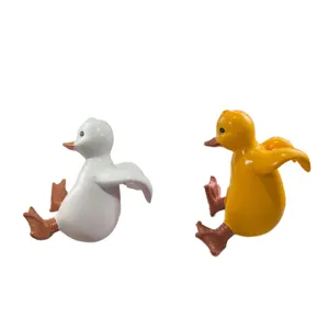Cute resin hanging duck figurines for flower pots, pair of white and yellow decorative animals.