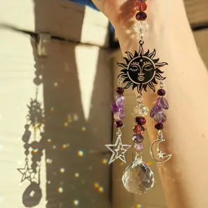 Amethyst crystal suncatcher featuring a sun, moon, and star design with hanging prism ball.