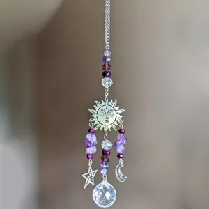 Detailed view of crystal suncatcher with purple amethyst beads, sun, moon and star charms.
