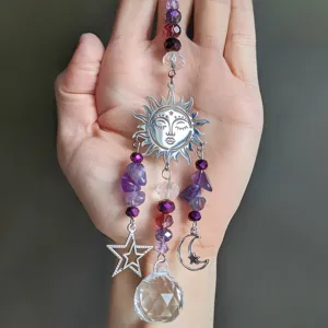 Amethyst crystal suncatcher with sun, moon, and star charms for window hanging and decor.