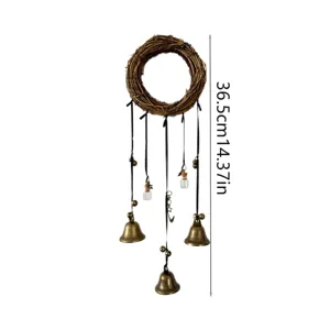 Boho twig wreath wind chime with vintage bronze bells and glass bottles hanging decor detail.