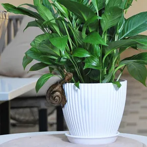 Resin snail hanging ornament for plant pot and garden decoration, detailed bronze finish sculpture.