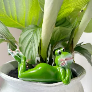 Close-up detail shot of cute green frog resin figurine, perfect for desk and potted plant decor.