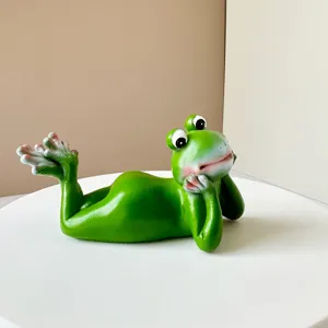 Close-up detail of creative green frog resin figurine tabletop decor ornament cute design.