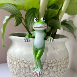 Detail view of cute green frog resin pot hanger, creative plant bonsai hanging ornament decor