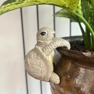 Resin turtle flower pot hanging figurine, detail shot of cute garden plant pot decoration.