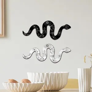 Detailed shot of bohemian wooden snake wall art featuring elegant floral patterns.