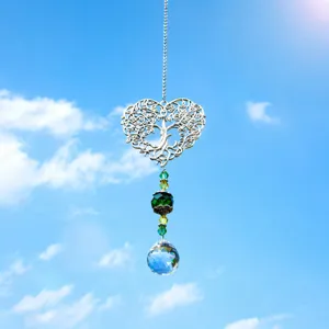 Close-up view of crystal suncatcher tree of life heart pendant hanging decor detail.