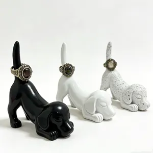 Close-up of cute resin dachshund ring holder detail, creative dog jewelry storage display.