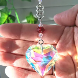 Crystal suncatcher detail showing vibrant rainbow prism reflections on a hanging heart.